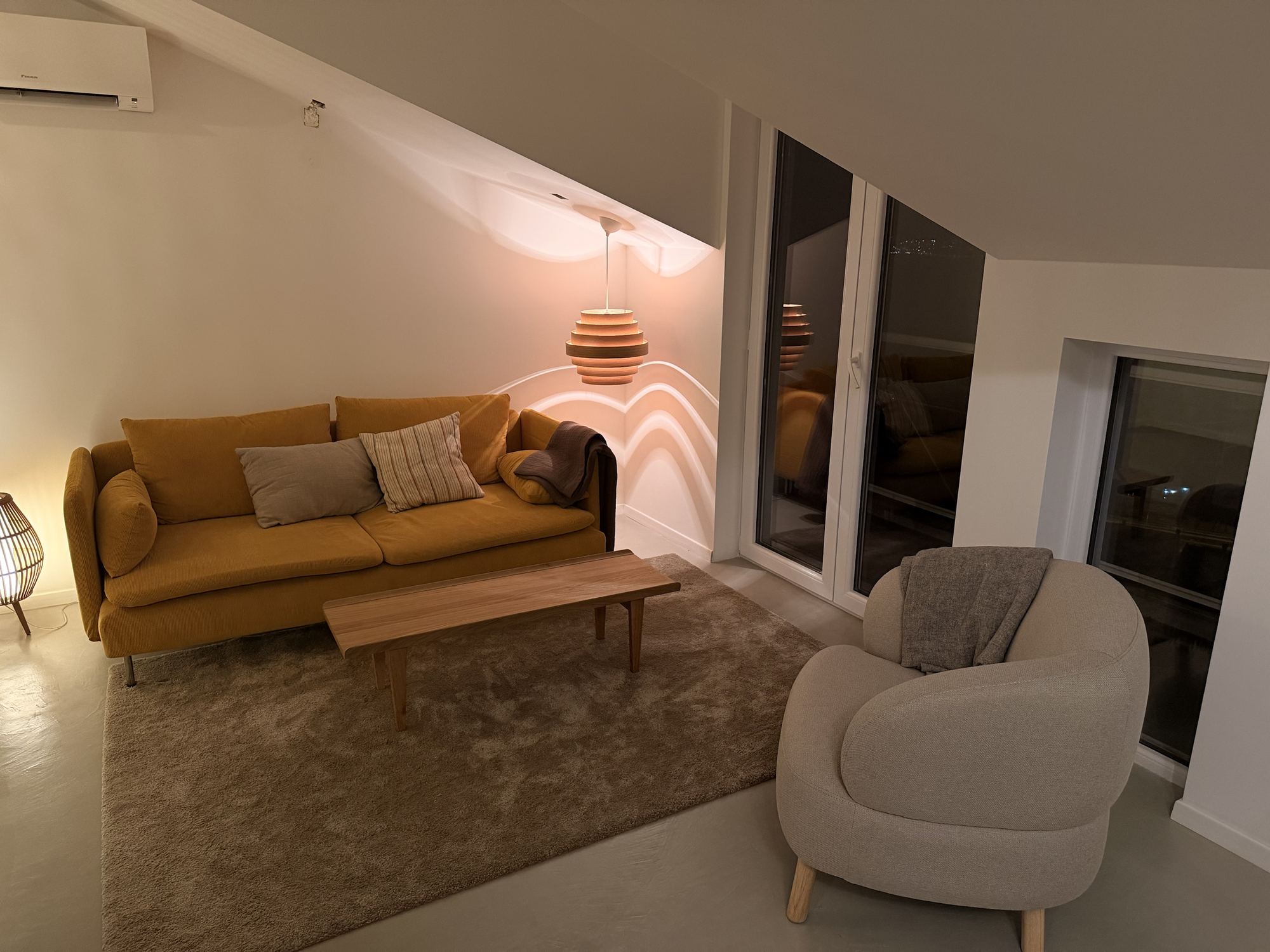 Living room with mustard sofa and reading corner